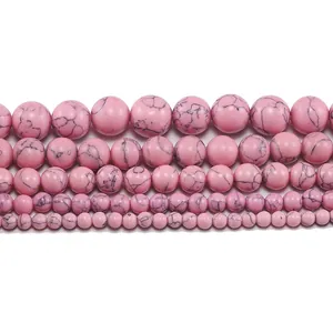 Macro view of round pink turquoise beads in five sizes with black marble veins