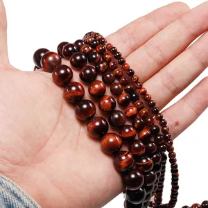 Natural red tiger eye stone beads in multiple sizes showing silk luster and chatoyancy