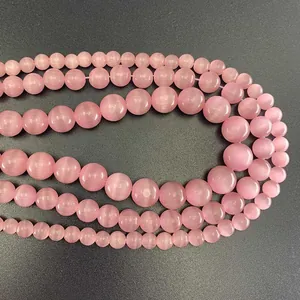 Macro shot of pink cat eye beads in various sizes for DIY jewelry bracelet making