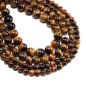 Macro view of natural tiger eye stone beads showing glossy brown cat-eye textures