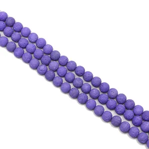 Macro detail of natural purple lava rock beads with porous texture for DIY jewelry making