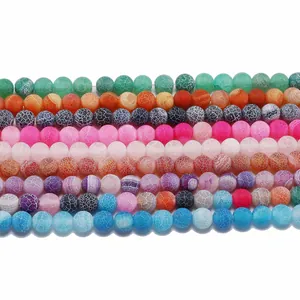 Close-up of weathered agate round beads with dragon vein texture in diverse vibrant colors