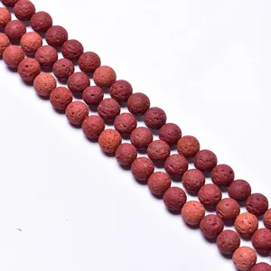 Macro detail of red volcanic lava stone round beads showing natural porous texture for DIY jewelry