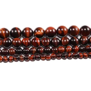 Detailed view of polished natural red tiger eye beads in multiple sizes for DIY jewelry