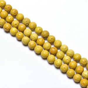 Macro detail of mustard yellow volcanic rock round beads with natural porous texture