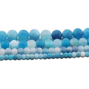 Macro detail of weathered blue agate round beads in various sizes for DIY jewelry making