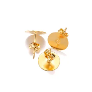 Detailed view of golden stainless steel flat pad earring studs with butterfly backs