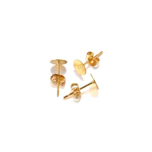 Detail view of gold stainless steel flat head earring studs with butterfly backs