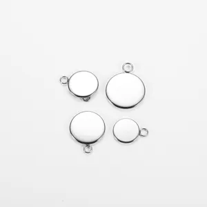 Close-up of four stainless steel bezel pendant trays with loops for jewelry making