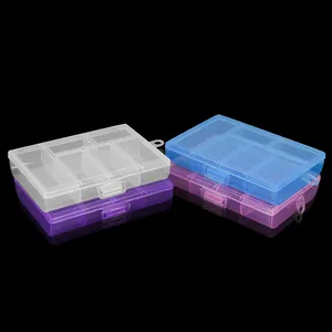 Detail of four colorful plastic organizers with 6 compartments and secure snap lids