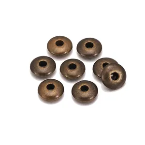 Macro shot of 8mm bronze metal disc spacer beads for DIY jewelry making jewelry