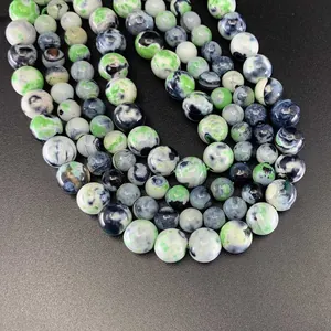 Macro shot of green and white marbled natural fire agate round beads for jewelry making