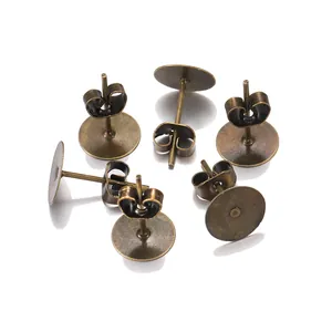 Macro view of bronze DIY earring posts with flat base and butterfly backs set