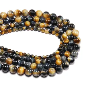 Macro shot of polished yellow and blue tiger eye stone beads with cat-eye effect texture