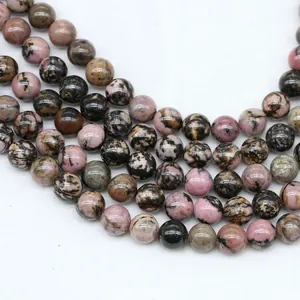Macro view of polished natural rhodonite beads with pink and black stone textures