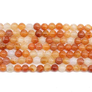 Strand of orange red dragon vein agate beads showing natural cracked patterns and gradients