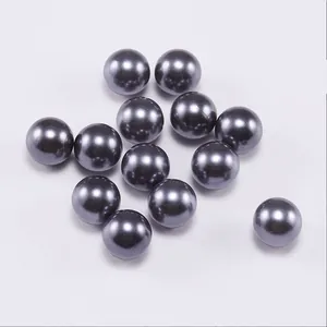 Close-up of metallic dark grey ABS imitation pearls with smooth reflective surface
