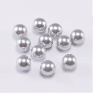 Close-up of high-gloss silver ABS imitation pearls with smooth metallic finish for DIY jewelry