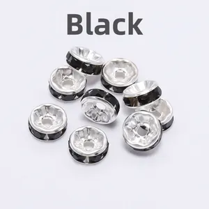 Macro shot of silver metal rondelle spacer beads with black rhinestones for DIY jewelry