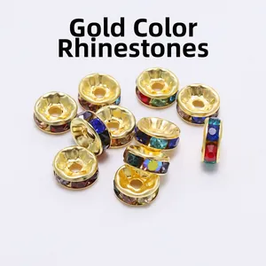 Macro view of gold rondelle beads with multicolored rhinestones for DIY jewelry making