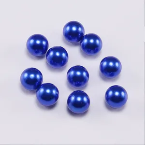 Macro shot of dark blue round ABS faux pearls for DIY jewelry making and crafts