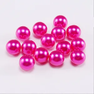 Close-up of vibrant pink round imitation pearls with glossy finish for DIY jewelry crafts