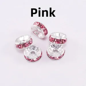 Macro detail of silver-plated spacer beads with pink rhinestones for DIY jewelry making