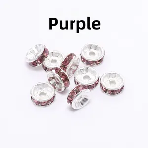 Detailed close-up of silver-plated rondelle spacer beads with vibrant purple rhinestones