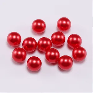 Close-up of vibrant red round faux pearls with glossy finish for DIY jewelry making