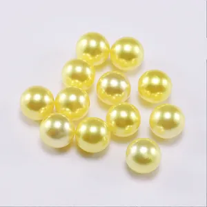 Close-up of smooth lemon yellow ABS imitation pearls with glossy finish for DIY jewelry
