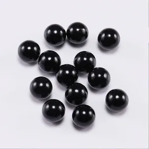 Close-up of polished black round acrylic spacer beads for DIY jewelry making