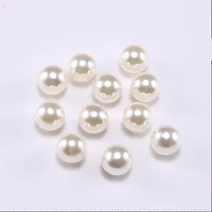 Macro shot of smooth cream white round ABS faux pearls with glossy finish for DIY jewelry