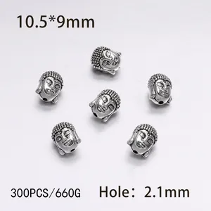 Macro shot of 300 pieces silver Buddha head alloy beads for DIY jewelry making