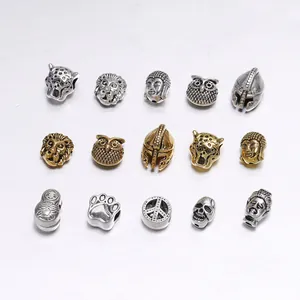 Flat lay detail of assorted antique gold and silver DIY animal head metal beads and spacers