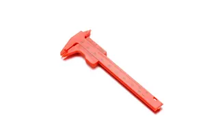 Mini orange plastic vernier caliper tool with metric and imperial scales for DIY measurement