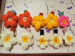 Detailed macro view of handmade crochet flower hair clips with colorful yarn texture