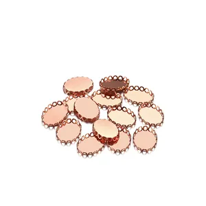Detailed macro of rose gold oval jewelry settings with delicate filigree lace edges