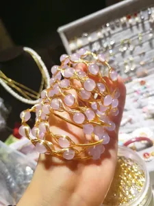 Detail of pink crystal bead bracelets with gold wire wrapping in a vintage DIY jewelry style