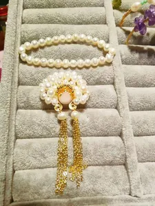 Detail of traditional Chinese phoenix jewelry with golden tassels and freshwater pearls