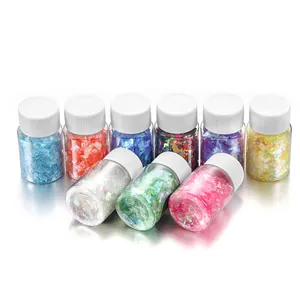 Detail of 9 bottles containing colorful iridescent glitter flakes for resin DIY crafts