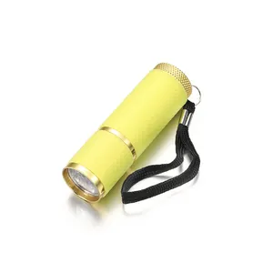 Mini LED nail dryer flashlight in neon yellow with non-slip texture and hand strap