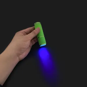 Mini 12W UV LED nail lamp flashlight showing blue light beam for quick gel drying