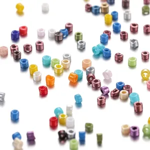Macro view of assorted 2mm colorful plastic seed beads with pearlescent finish for DIY
