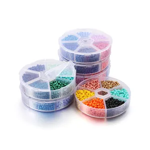 Vue détaillée de perles de rocaille multicolores dans des boîtes de rangement en plastique