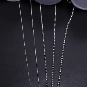 Macro detail of silver steel ball chains in four different diameters for DIY jewelry making