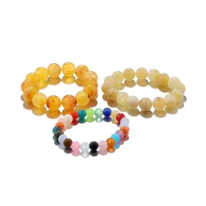 Macro detail of various colorful round gemstone beads including amber and rainbow styles