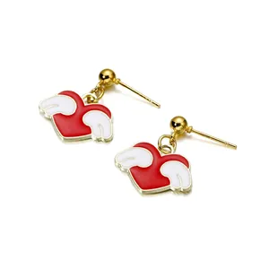 Golden heart earrings with white wings and red enamel finish on white background