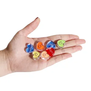 Colorful acrylic heart beads with smile faces held in hand for DIY jewelry size reference