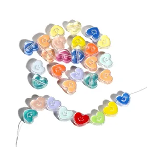 Close-up of colorful acrylic heart beads with smiley faces for DIY jewelry making