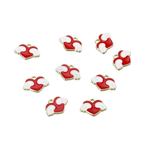 Detail of red enamel heart charms with white wings and gold alloy trim for DIY jewelry